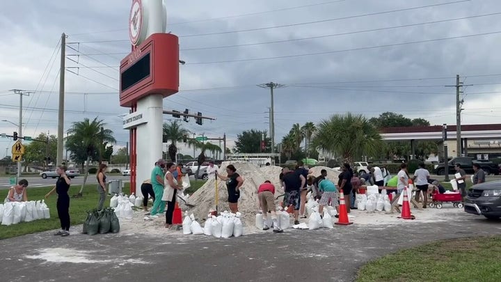 Florida residents shovel piles of sand into bags as Idalia nears