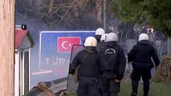 Greece fires tear gas at migrants trying to cross border from Turkey