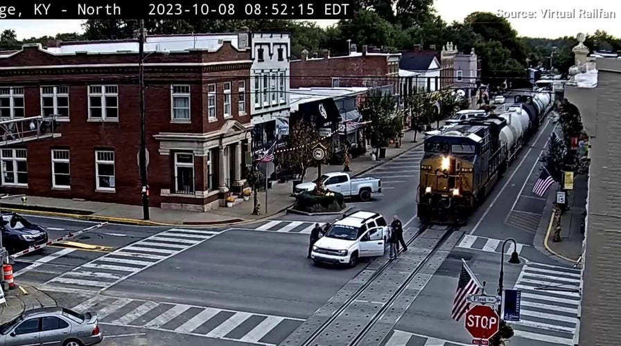 Good Samaritans push woman and kids in stalled SUV out of moving train's path
