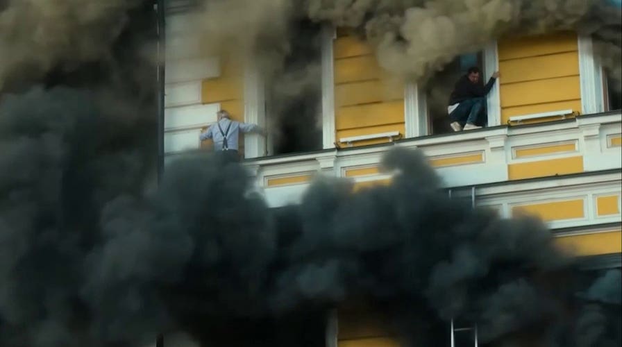 Men cling to side of Ukrainian building after fiery Russian attack