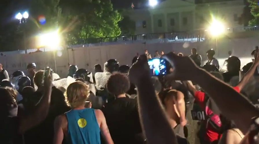 Protesters clash with Secret Service officers outside the White House