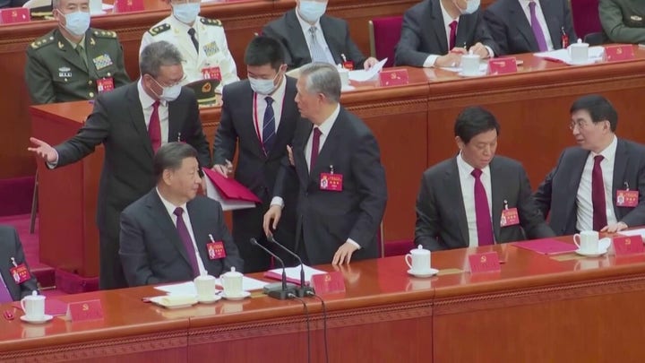 Chinese President Xi's predecessor Hu escorted out of party summit