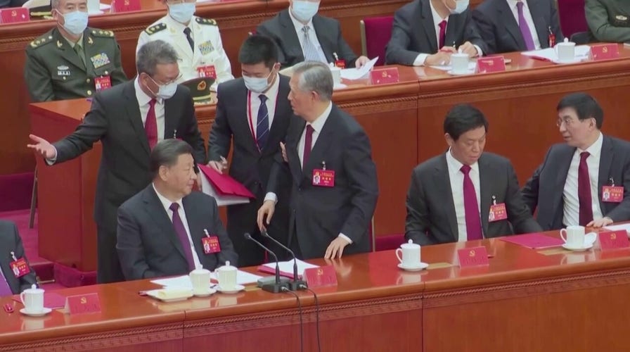 Chinese President Xi's predecessor Hu escorted out of party summit