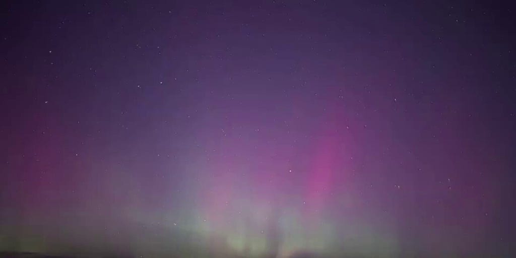 Aurora lights up night sky over Lake Michigan