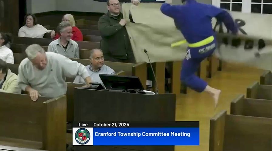 NJ candidate kung fu kicks protest signs in bizarre town hall meeting video