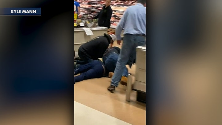 Customers subdue man who allegedly coughed and spit on store's produce