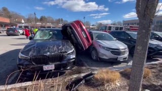 Audi wedged on side after parking lot crash - Fox News