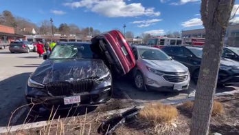 Audi wedged on side after parking lot crash