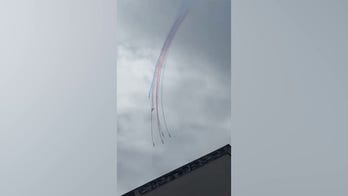 Military jets collide in midair stunt as pilots parachute to safety