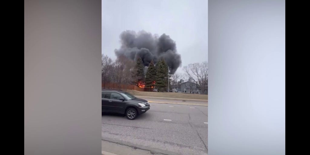 Home is engulfed in flames following a plane crash