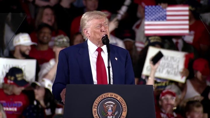 Trump laughs off protester who attempted to disrupt 100 days speech: ‘Thought it was a guy’