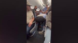 American Airlines passenger restrained after attempting to open emergency door in-flight - Fox News