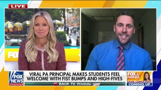 Principal spreads joy in school with fist-bumps and high-fives
