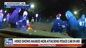 Video shows masked mob attacking police car in Maryland