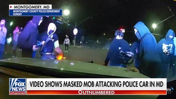 Video shows masked mob attacking police car in Maryland