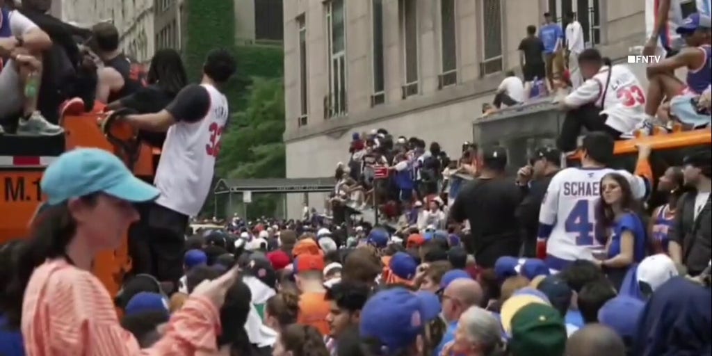 Knicks fans climb on NYPD car, sanitation trucks at jam-packed NBA championship parade