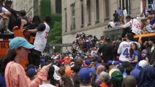Knicks fans climb on NYPD car, sanitation trucks at jam-packed NBA championship parade