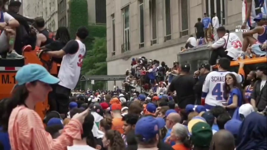 Knicks fans climb on NYPD car, sanitation trucks at jam-packed NBA championship parade