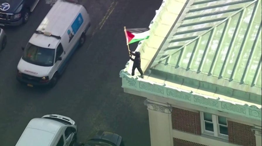 Aerial view shows an anti-Israel protester waving a Palestinian flag on the roof of Columbias Hamilton Hall