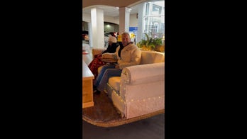 Couple buckles up as sofa car spotted driving through busy Kentucky street