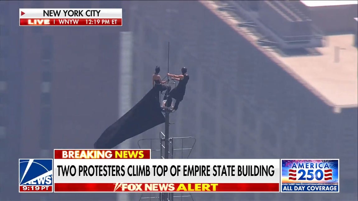Masked protesters scale Empire State Building spire