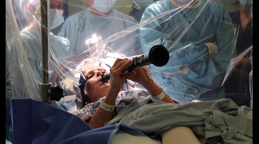 Woman with Parkinson’s plays clarinet during operation in remarkable scene