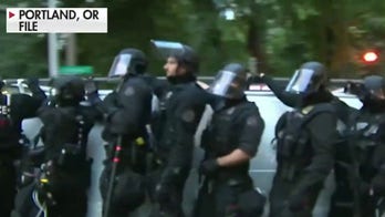 Portland police declare riot after fire set at precinct