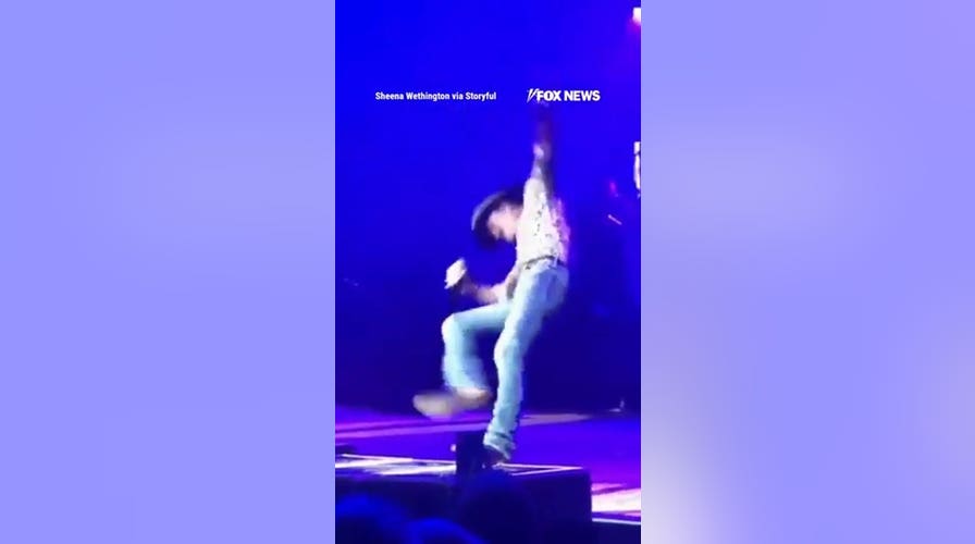 Tim McGraw takes a TUMBLE off platform during concert
