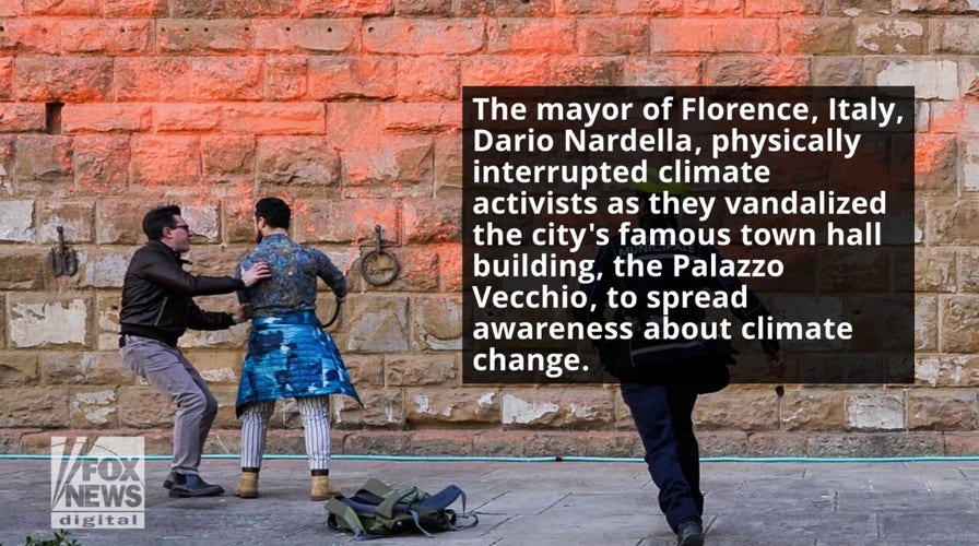 Mayor of Florence, Italy, physically stops climate activists from vandalizing historic town hall building