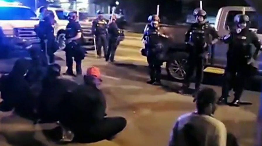 Louisville police declare 'unlawful assembly' after protesters smashed windows