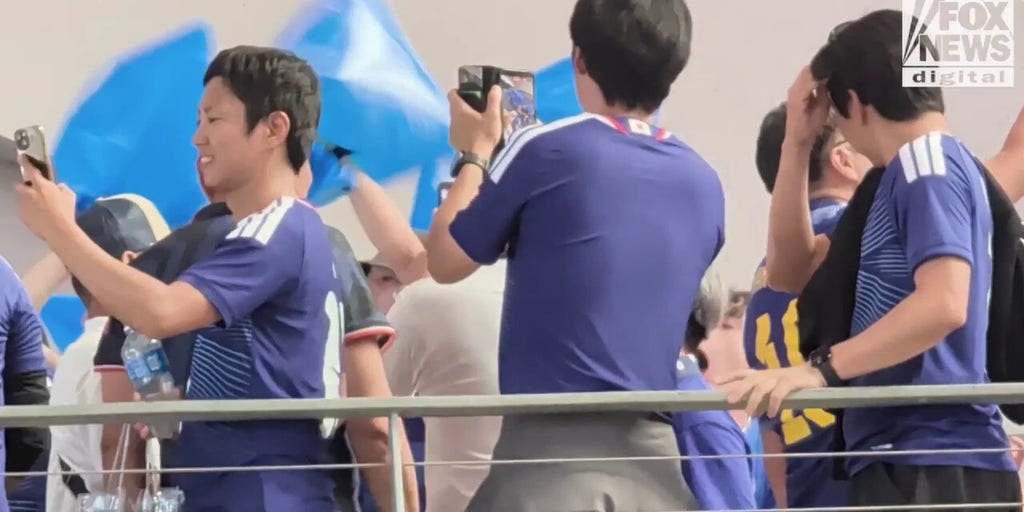 Japanese soccer fans erupt in a chant before their World Cup opening match in Dallas