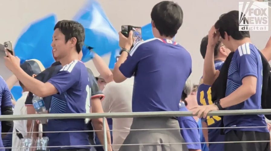 Japanese soccer fans erupt in a chant before their World Cup opening match in Dallas