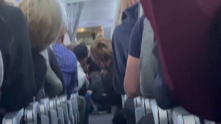 Unruly passenger subdued by passengers and flight attendants on American Airlines flight