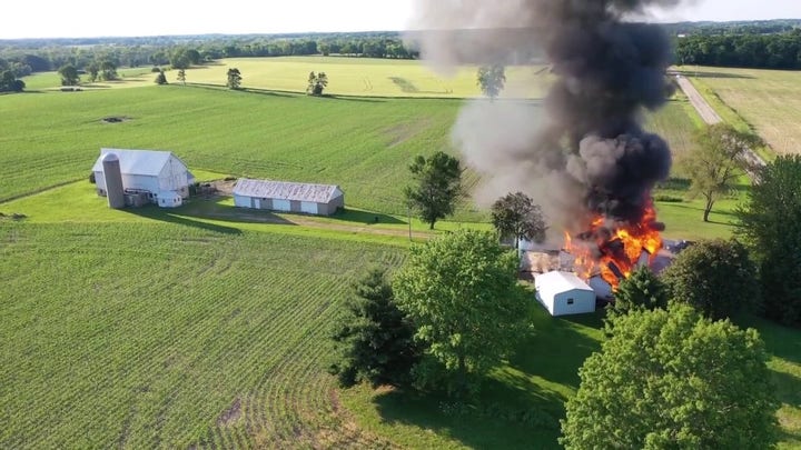 Chaotic police shootout captured on bodycam: 'Return fire from upper window' while drone footage captures a burning barn 