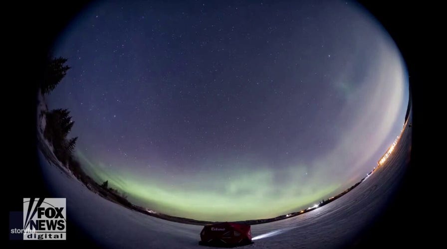 Northern lights seen over lake in stunning video