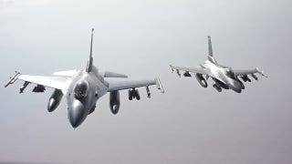 Air Force F-16 fighter jets refuel while flying over the Middle East