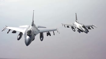 Air Force F-16 fighter jets refuel while flying over the Middle East