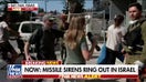 Israelis scramble to safety as sirens go off amid conflict with Iran