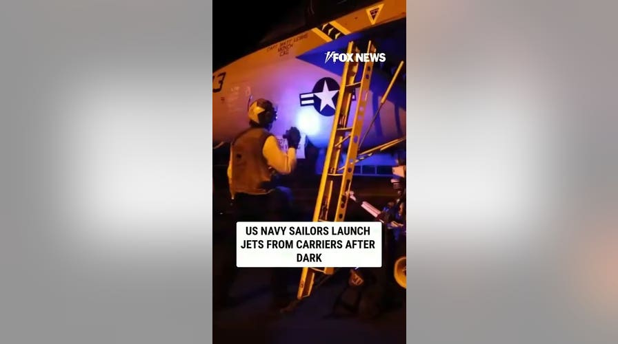 US Navy sailors launch jets from carriers after dark