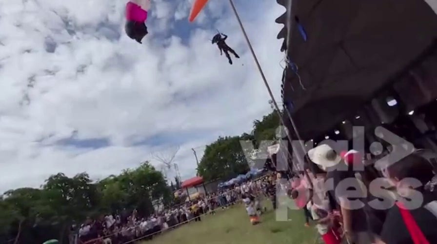 Paraglider loses control and crash lands through shop roof in Thailand