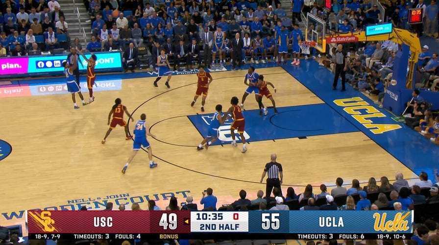 UCLA's Donovan Dent knocks down a three, beating the shot clock against the USC Trojans