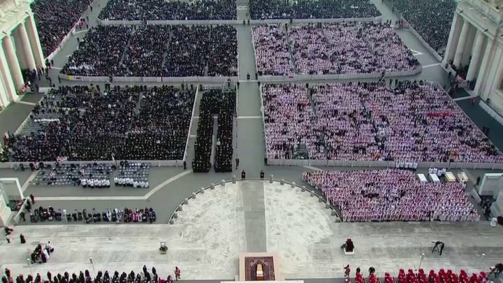 Thousands of mourners sing during the funeral mass for Pope Benedict