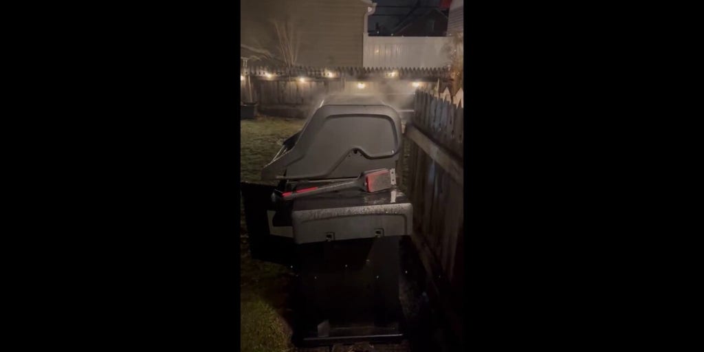 Ohio resident grills meal outside during stormy weather