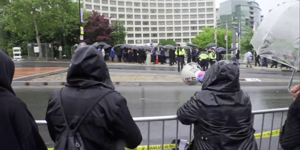 Dozens of protesters hold 'no war on Iran' signs outside White House Correspondents' Dinner