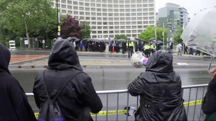 Dozens of protesters hold 'no war on Iran' signs outside White House Correspondents' Dinner