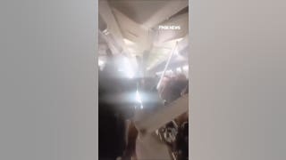 WATCH: Passengers SCREAM as VIOLENT TURBULENCE sends ceiling panels FLYING