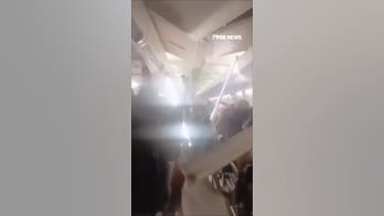 WATCH: Passengers SCREAM as VIOLENT TURBULENCE sends ceiling panels FLYING
