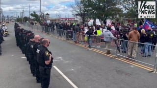 New Jersey authorities stand across from protesters outside Delaney Hall detention center