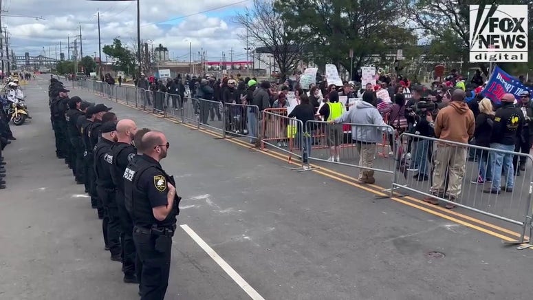New Jersey authorities stand across from protesters outside Delaney Hall detention center