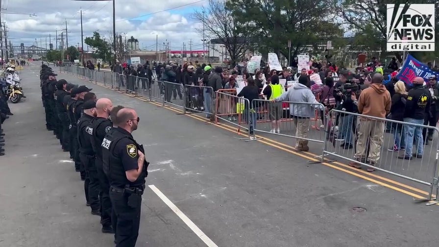 New Jersey authorities stand across from protesters outside Delaney Hall detention center